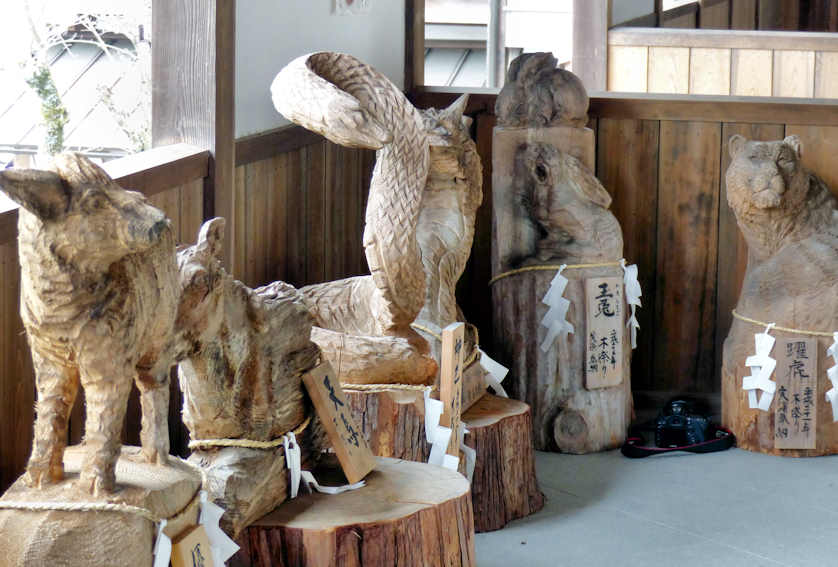 Carved by chainsaw, a collection of animal sculptures corresponding to the Chinese Zodiac on display at Idakiso Shrine.